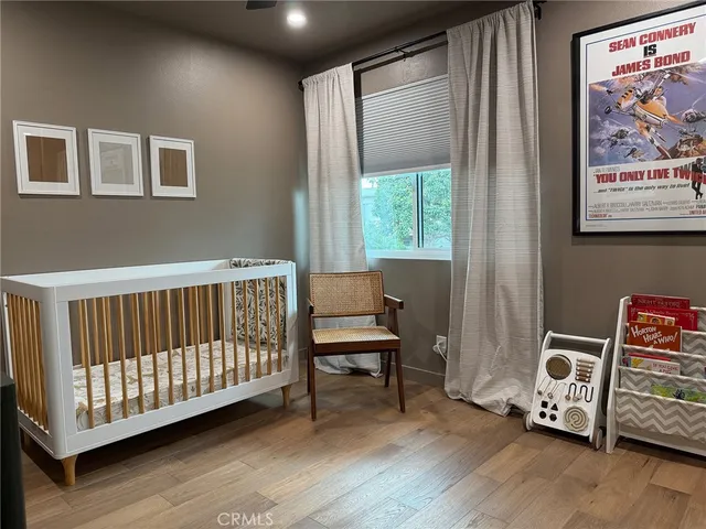 a view of a room with wooden floor furniture and windows