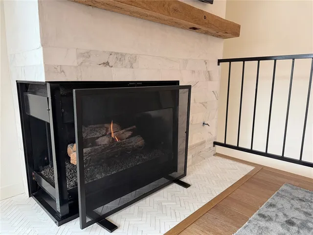 a view of a utility room with wooden floor and a fireplace