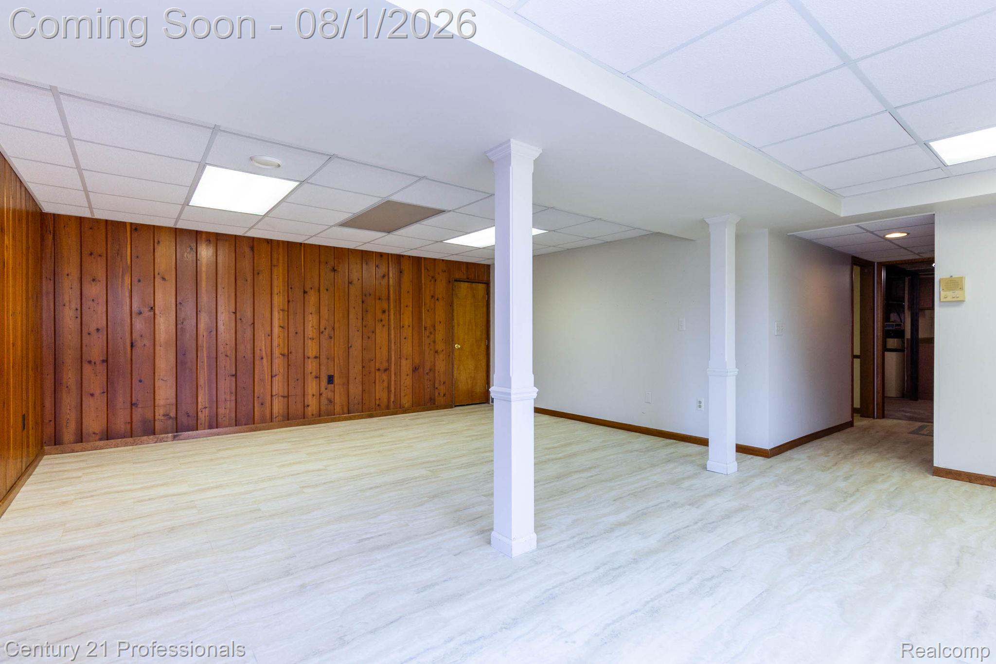 1365 East Buell Road Rochester, MI 48306 - Photo 27 of 56 Spacious lower level featuring light wood-finish flooring and a mix of paneled and painted walls