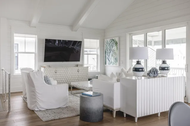 a dining room with furniture a chandelier and wooden floor