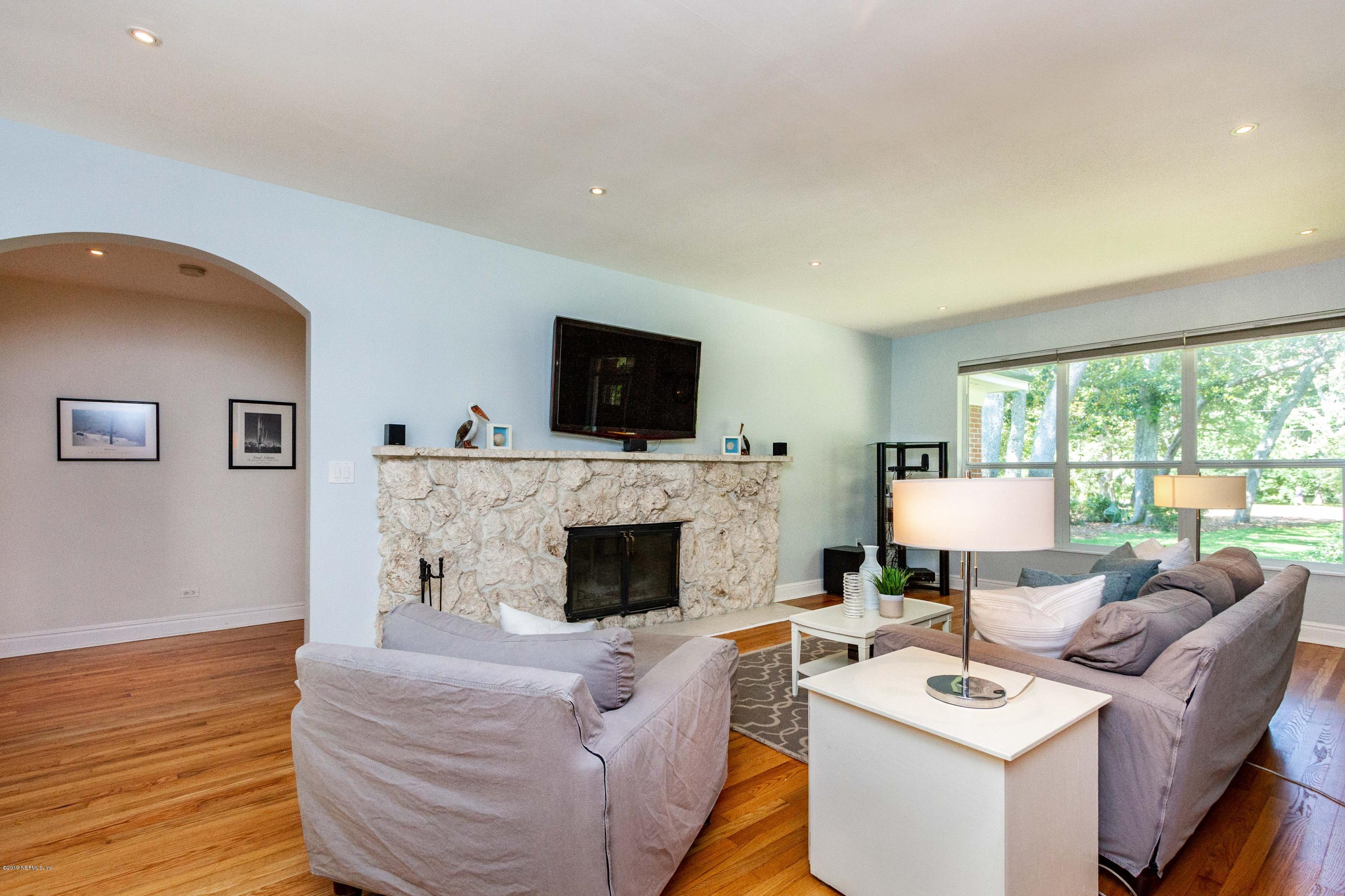 841 Penman Road Neptune Beach, FL 32266 - Photo 15 of 92 a living room with furniture a fireplace and a flat screen tv