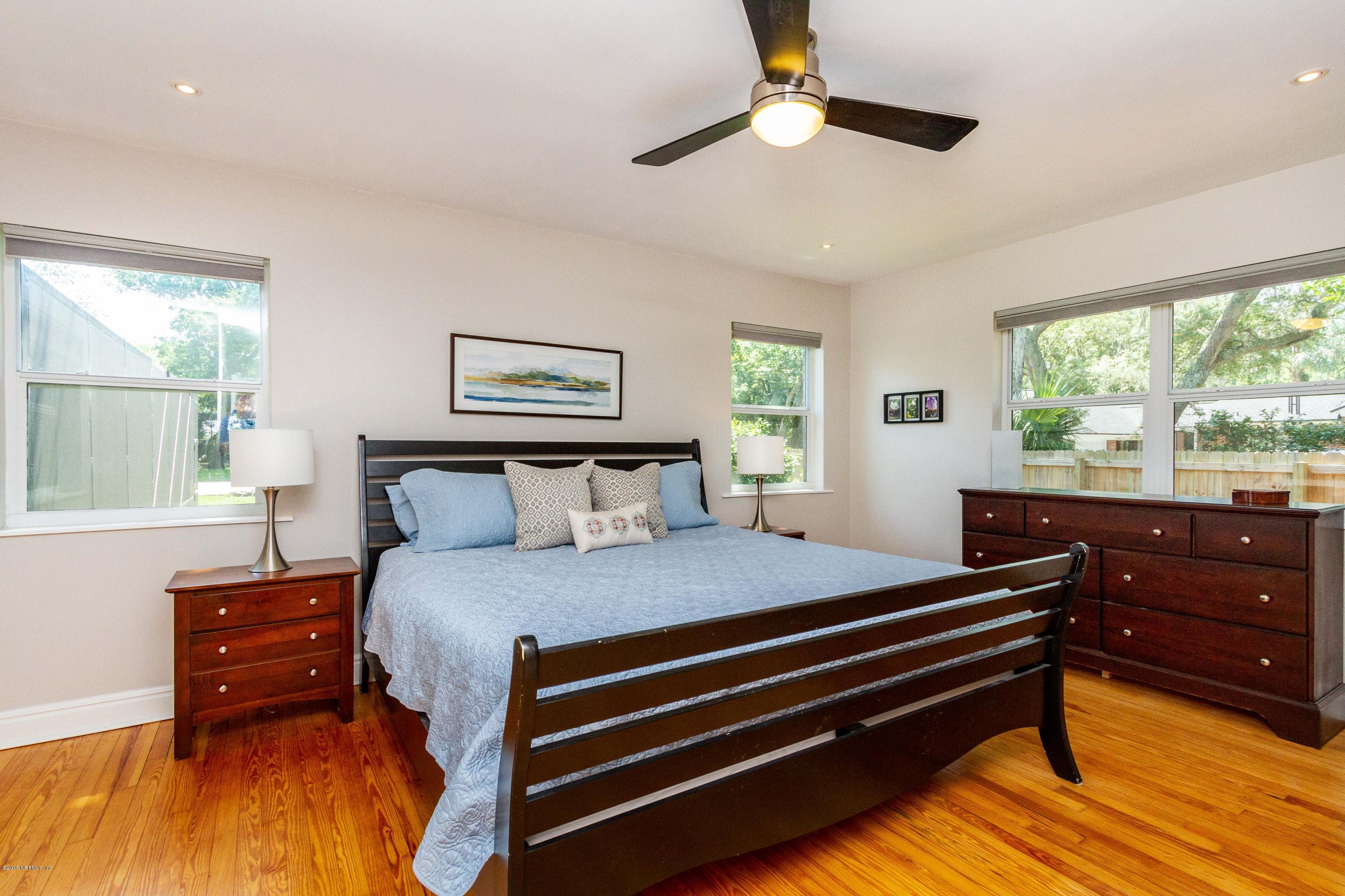 841 Penman Road Neptune Beach, FL 32266 - Photo 22 of 92 a bedroom with a bed and a dresser next to a window