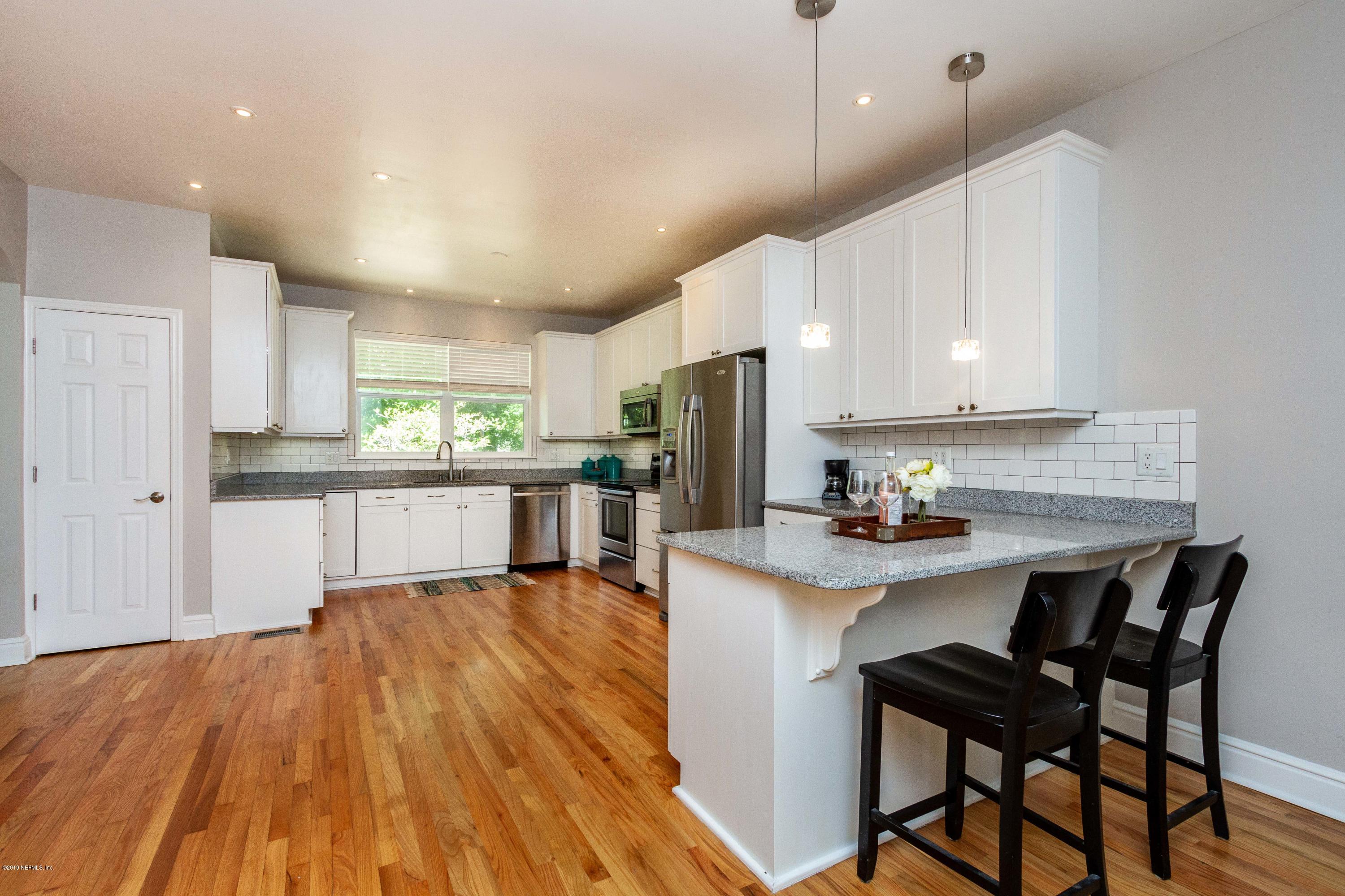841 Penman Road Neptune Beach, FL 32266 - Photo 10 of 92 a kitchen with stainless steel appliances a dining table chairs microwave and sink