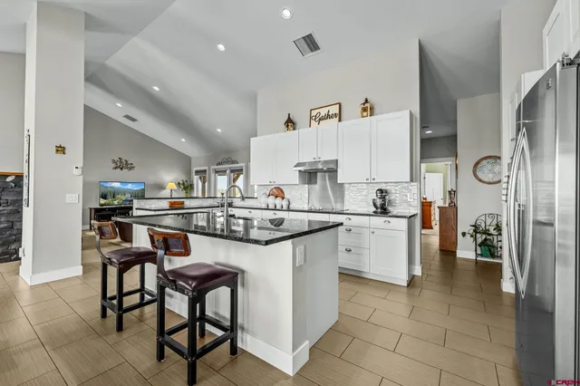 a kitchen with appliances a sink and cabinets