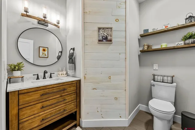 a bathroom with a toilet a sink and a mirror