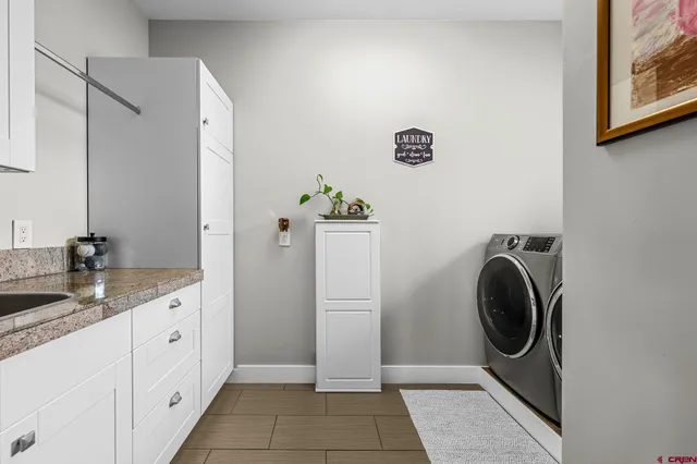 a utility room with mirror washer and dryer
