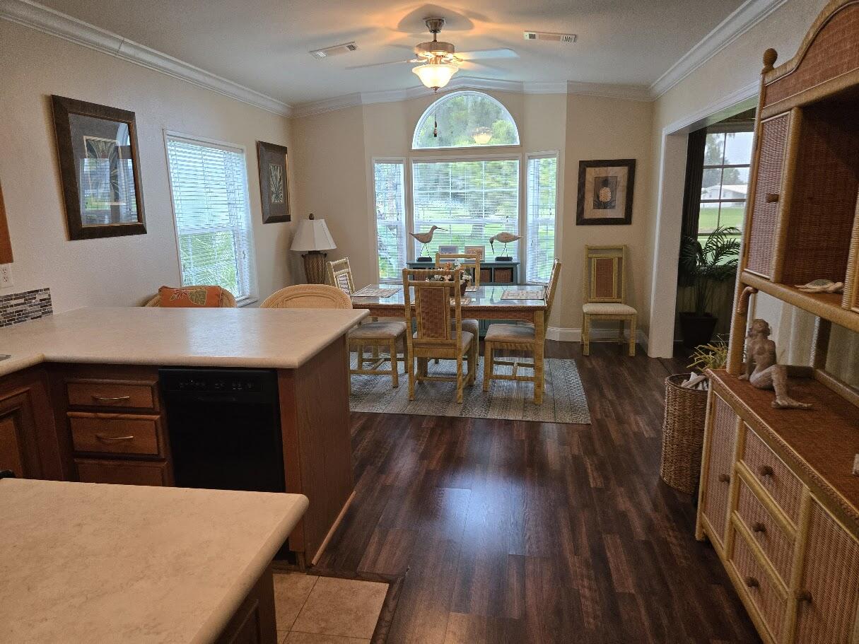 13680 Northwest 127th Terrace, Unit 17 Okeechobee, FL 34974 - Photo 16 of 30 a view of a dining room with furniture window and wooden floor