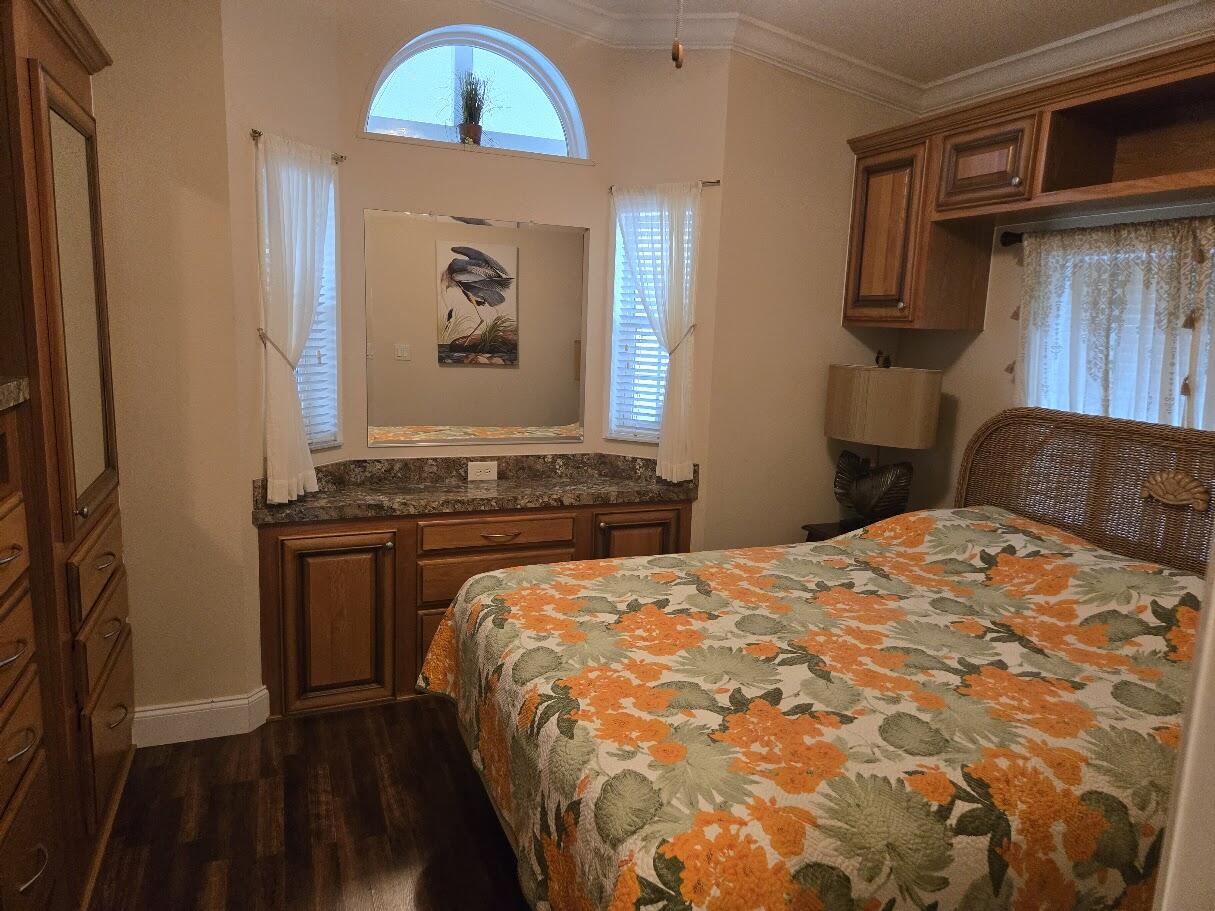 13680 Northwest 127th Terrace, Unit 17 Okeechobee, FL 34974 - Photo 25 of 30 a bedroom with a bed and a painting on the wall