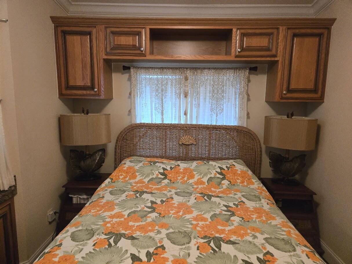 13680 Northwest 127th Terrace, Unit 17 Okeechobee, FL 34974 - Photo 26 of 30 a bedroom with a bed and wooden floor