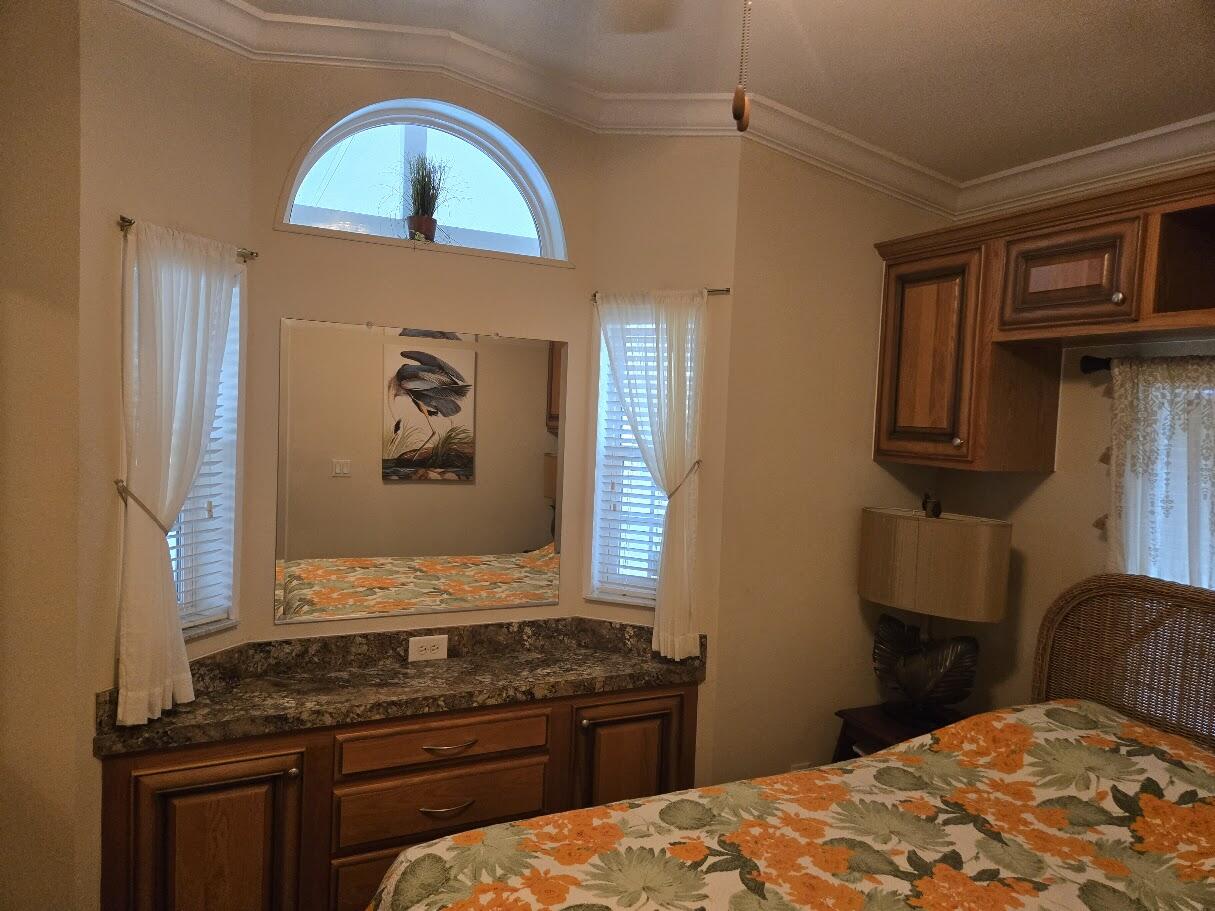 13680 Northwest 127th Terrace, Unit 17 Okeechobee, FL 34974 - Photo 29 of 30 a bedroom with a bed and a stove