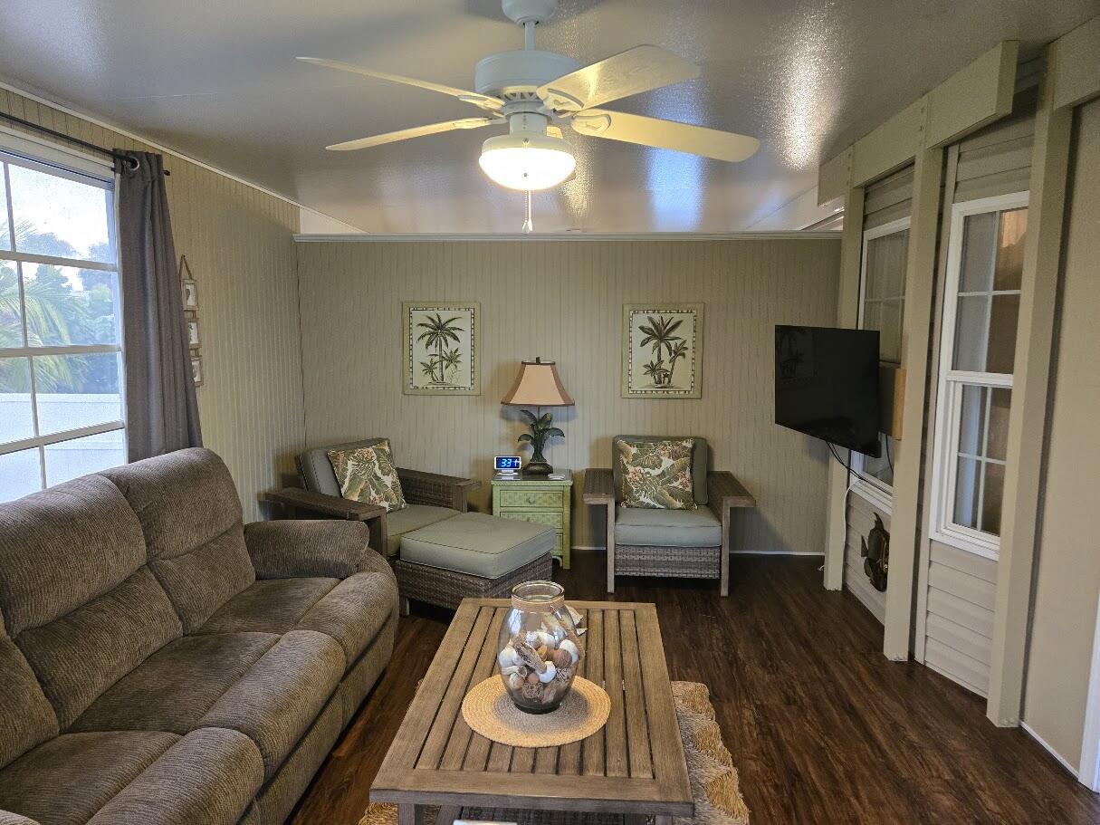 13680 Northwest 127th Terrace, Unit 17 Okeechobee, FL 34974 - Photo 3 of 30 a living room with furniture and a flat screen tv