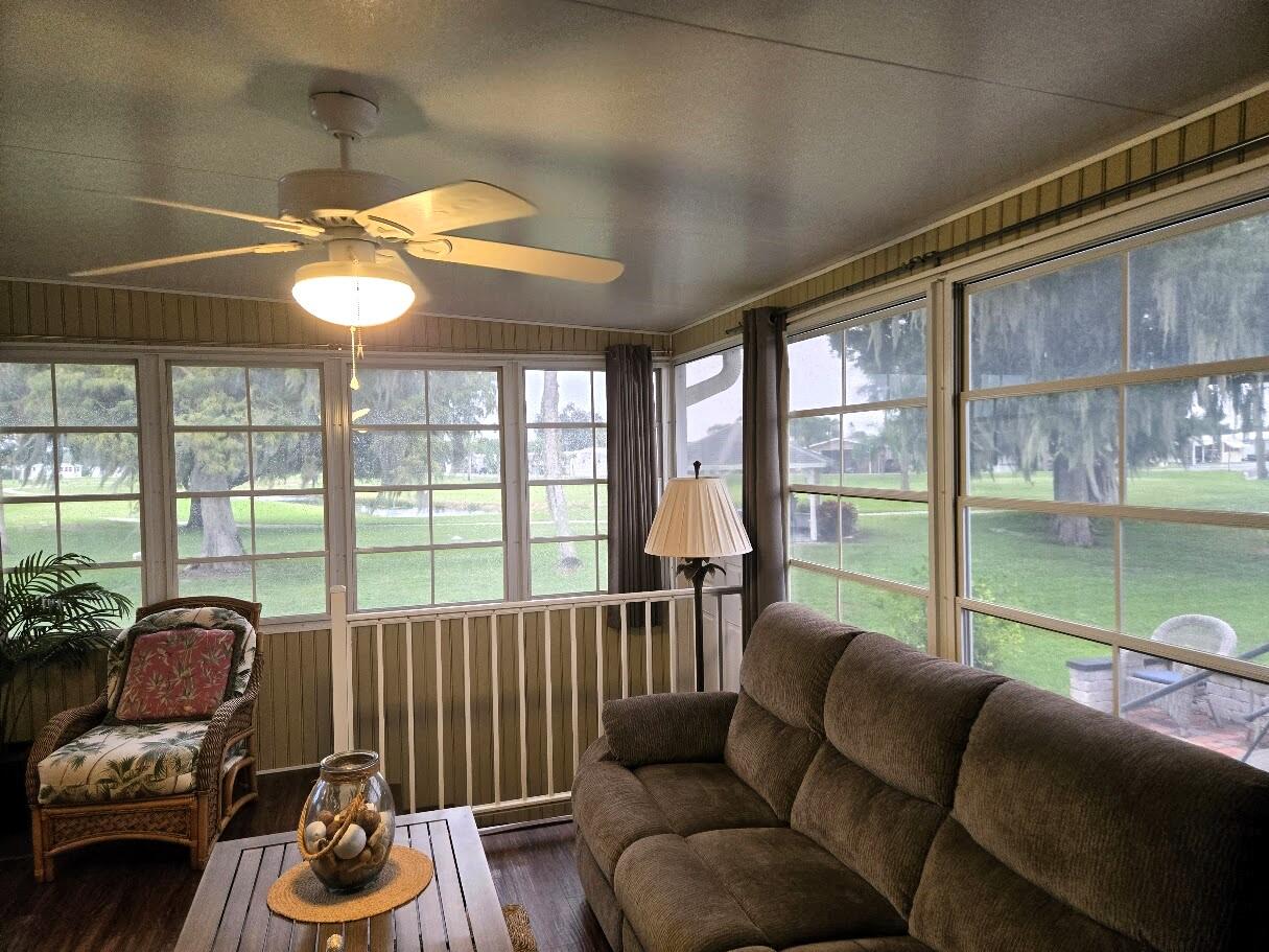 13680 Northwest 127th Terrace, Unit 17 Okeechobee, FL 34974 - Photo 4 of 30 a living room with furniture and a floor to ceiling window
