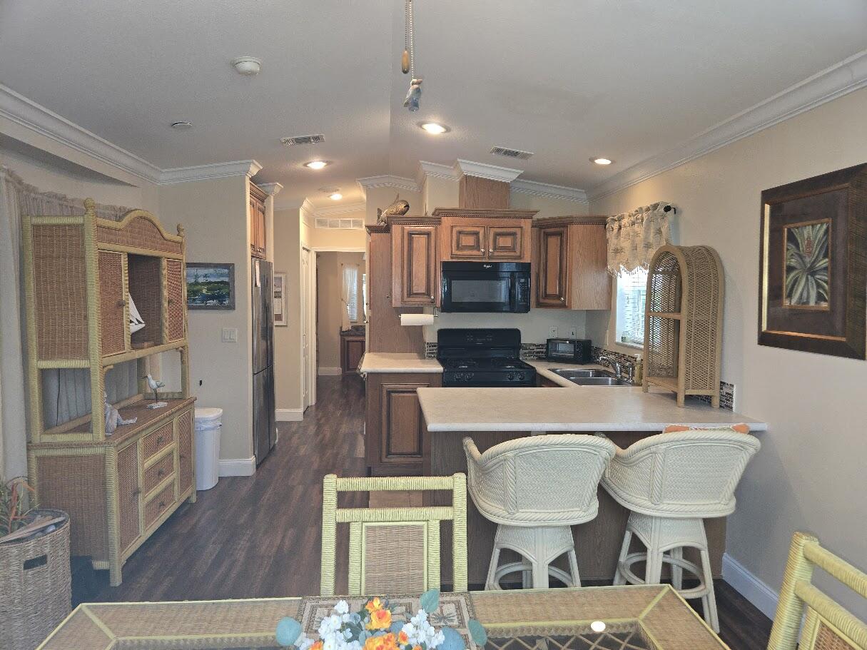 13680 Northwest 127th Terrace, Unit 17 Okeechobee, FL 34974 - Photo 9 of 30 a view of kitchen with cabinets and wooden floor