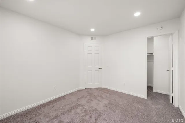 an aerial view of a house with a garden and lake view