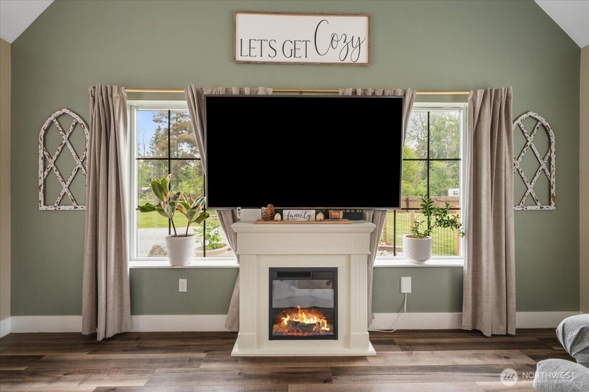 26709 Entwhistle Road East Buckley, WA 98321 - Photo 15 of 40 a living room with a fireplace and a flat screen tv