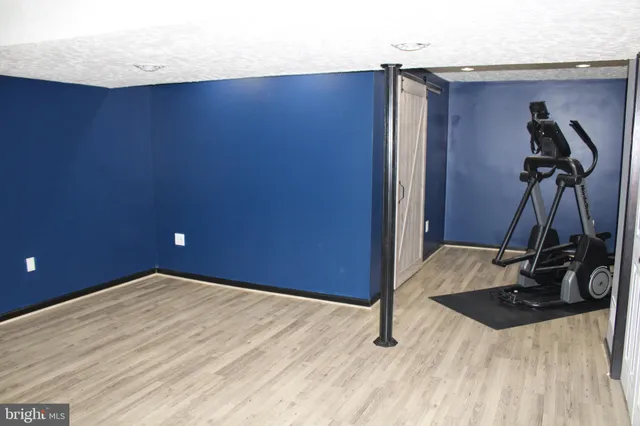 a room with a wooden floor and gym equipment