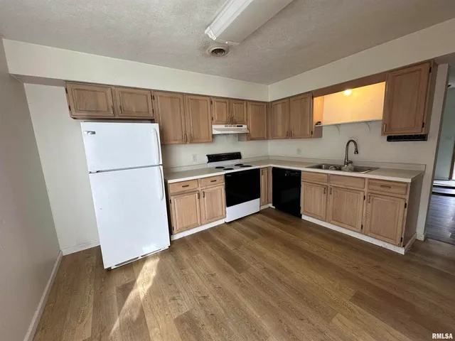 a kitchen with white cabinets and white appliances
