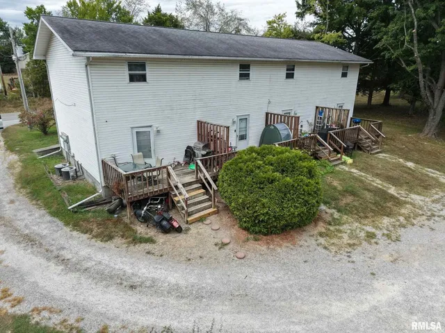a view of a backyard with table and chairs