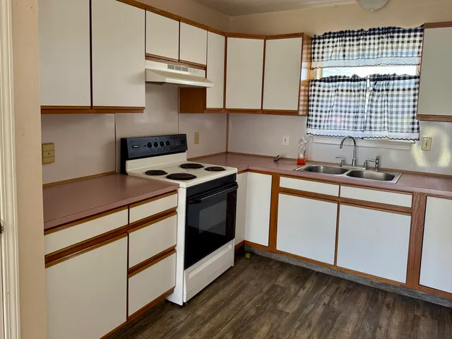 a kitchen with stainless steel appliances granite countertop a sink stove and cabinets