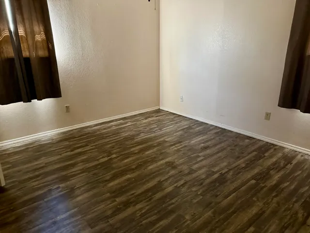 a view of a room with wooden floor