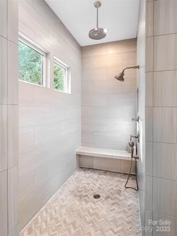 a bathroom with a bathtub and a shower