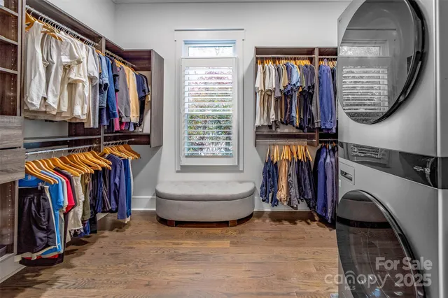 a view of walk in closet with clothes and shoes