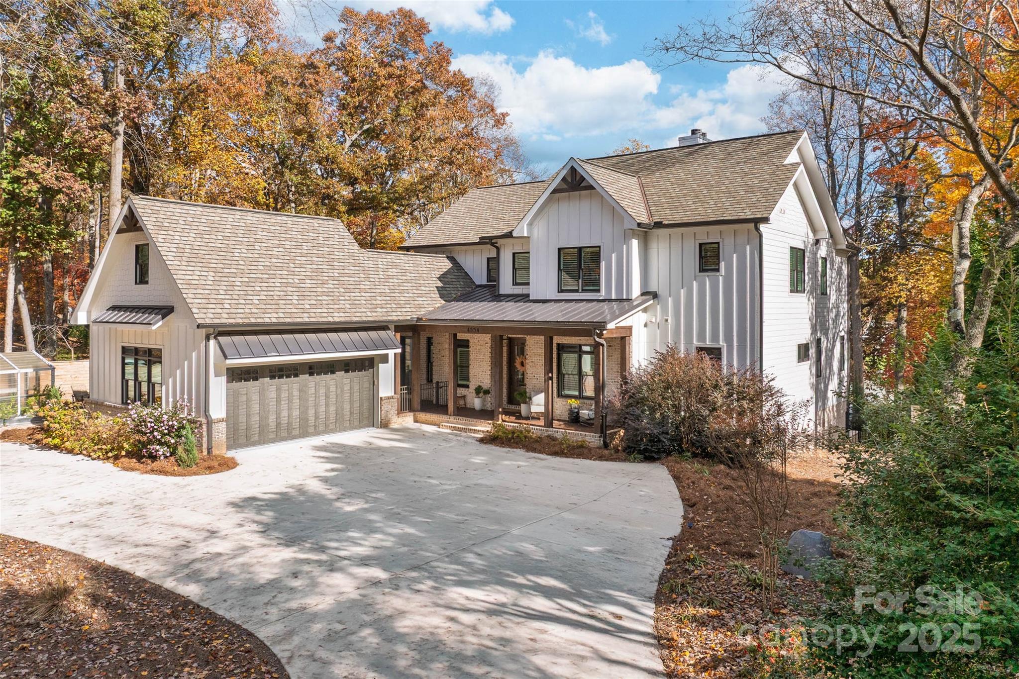 4554 Ina Lane Sherrills Ford, NC 28673 - Photo 2 of 44 a view of a white house with large trees and wooden fence