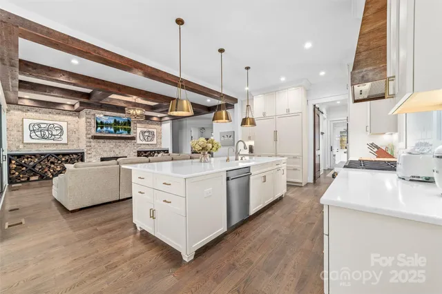 a kitchen with stainless steel appliances granite countertop a sink a stove and a refrigerator