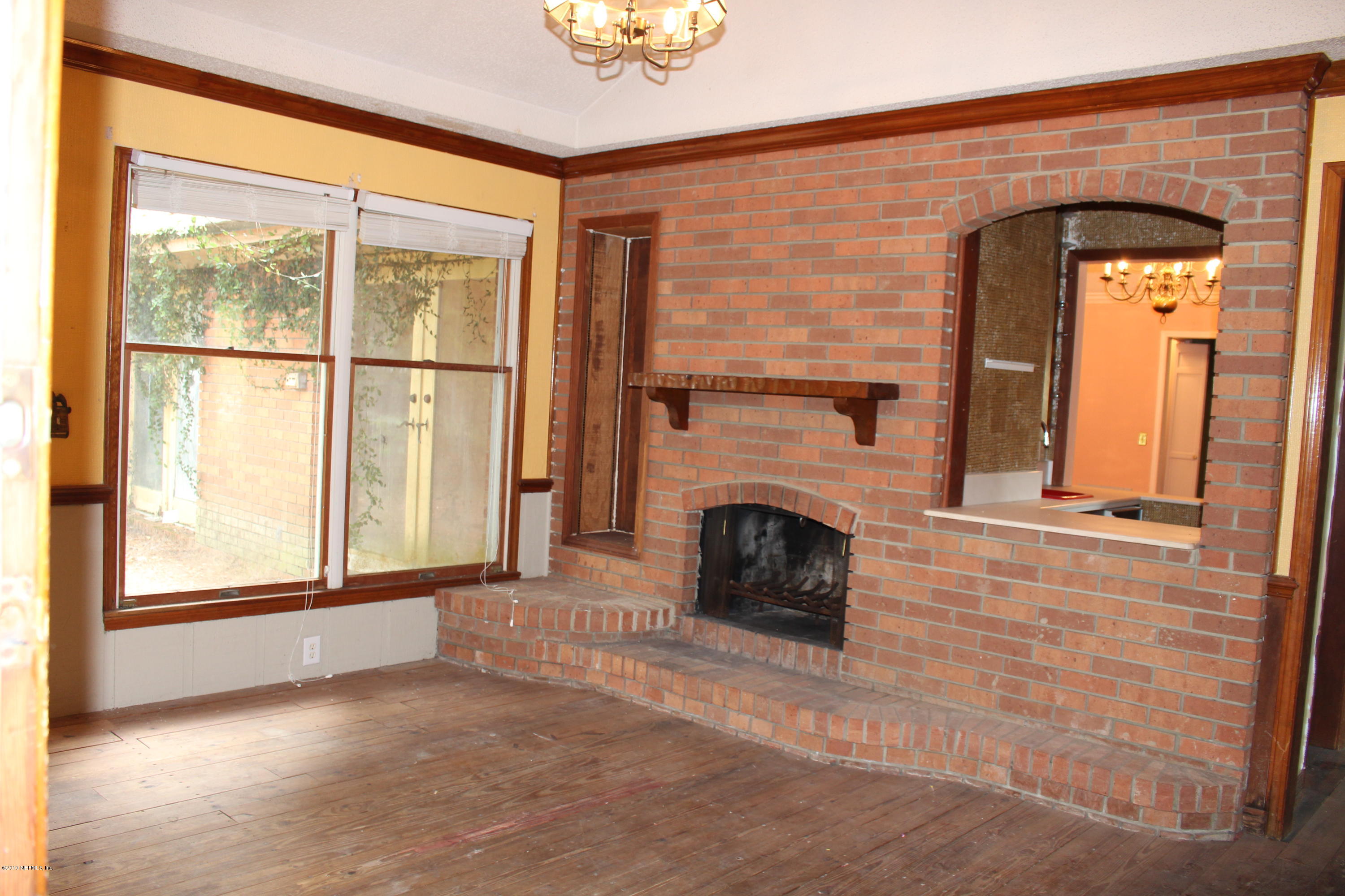 9656 Wexford Road Jacksonville, FL 32257 - Photo 8 of 18 a view of a livingroom with a fireplace and window