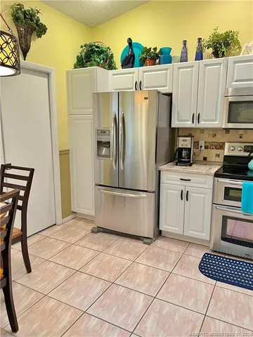 a view of a terrace with seating space and kitchen view