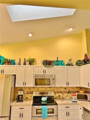 a kitchen with a stove sink and cabinets