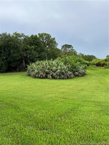 an aerial view of a pool with a patio