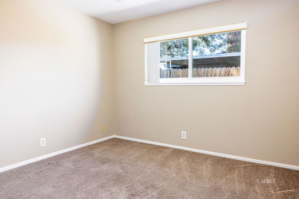 1144 West Benson Avenue Ridgecrest, CA 93555 - Photo 16 of 32 an empty room with a window
