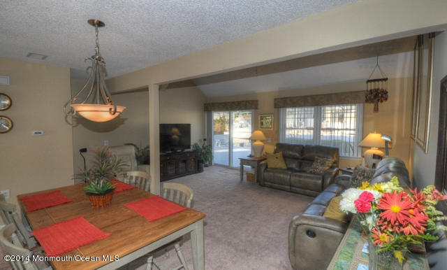 207 Allen Road Bayville, NJ 08721 - Photo 5 of 29 a living room with furniture and a chandelier