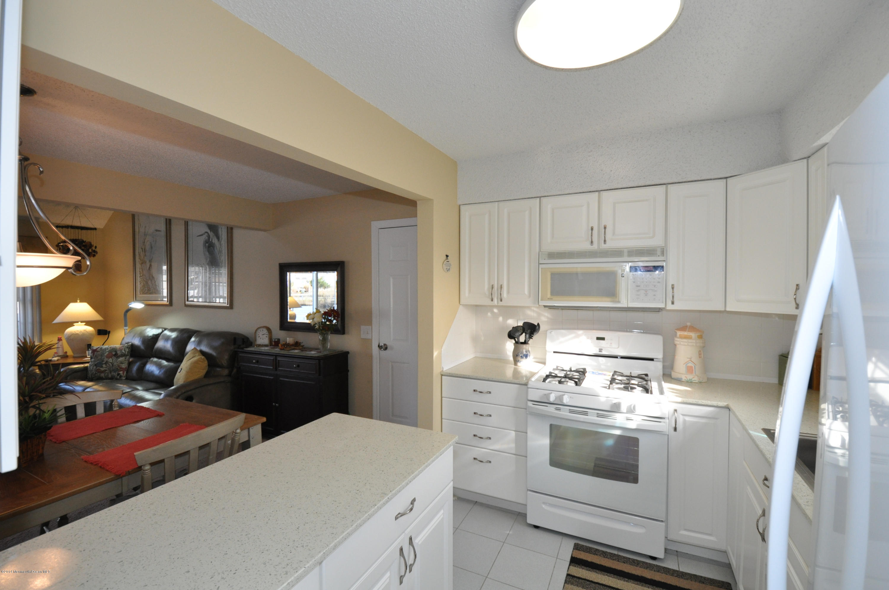 207 Allen Road Bayville, NJ 08721 - Photo 9 of 29 a kitchen with a stove a refrigerator and a stove