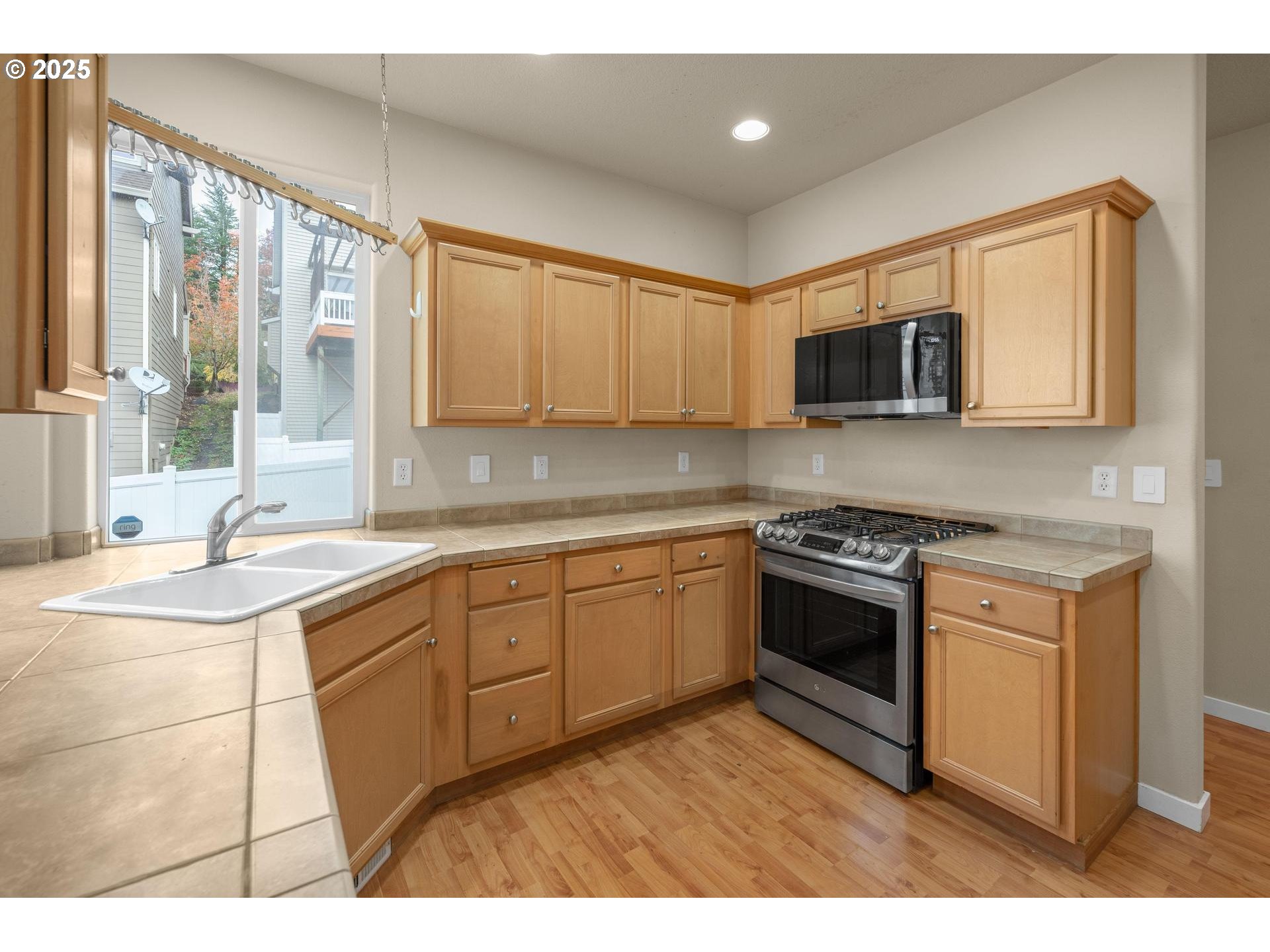 10797 Southwest Washington Street Portland, OR 97225 - Photo 12 of 48 a kitchen with stainless steel appliances granite countertop a stove a sink and a microwave