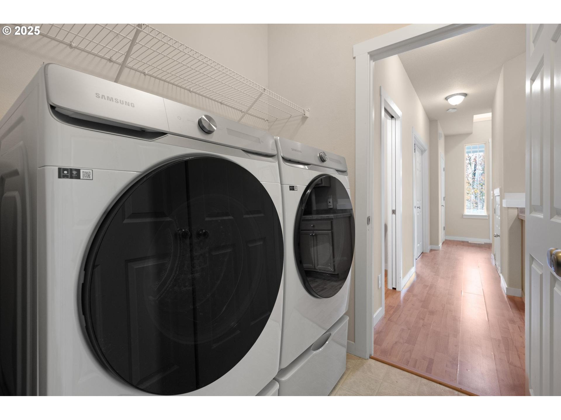 10797 Southwest Washington Street Portland, OR 97225 - Photo 24 of 48 a view of a hallway with washer and dryer