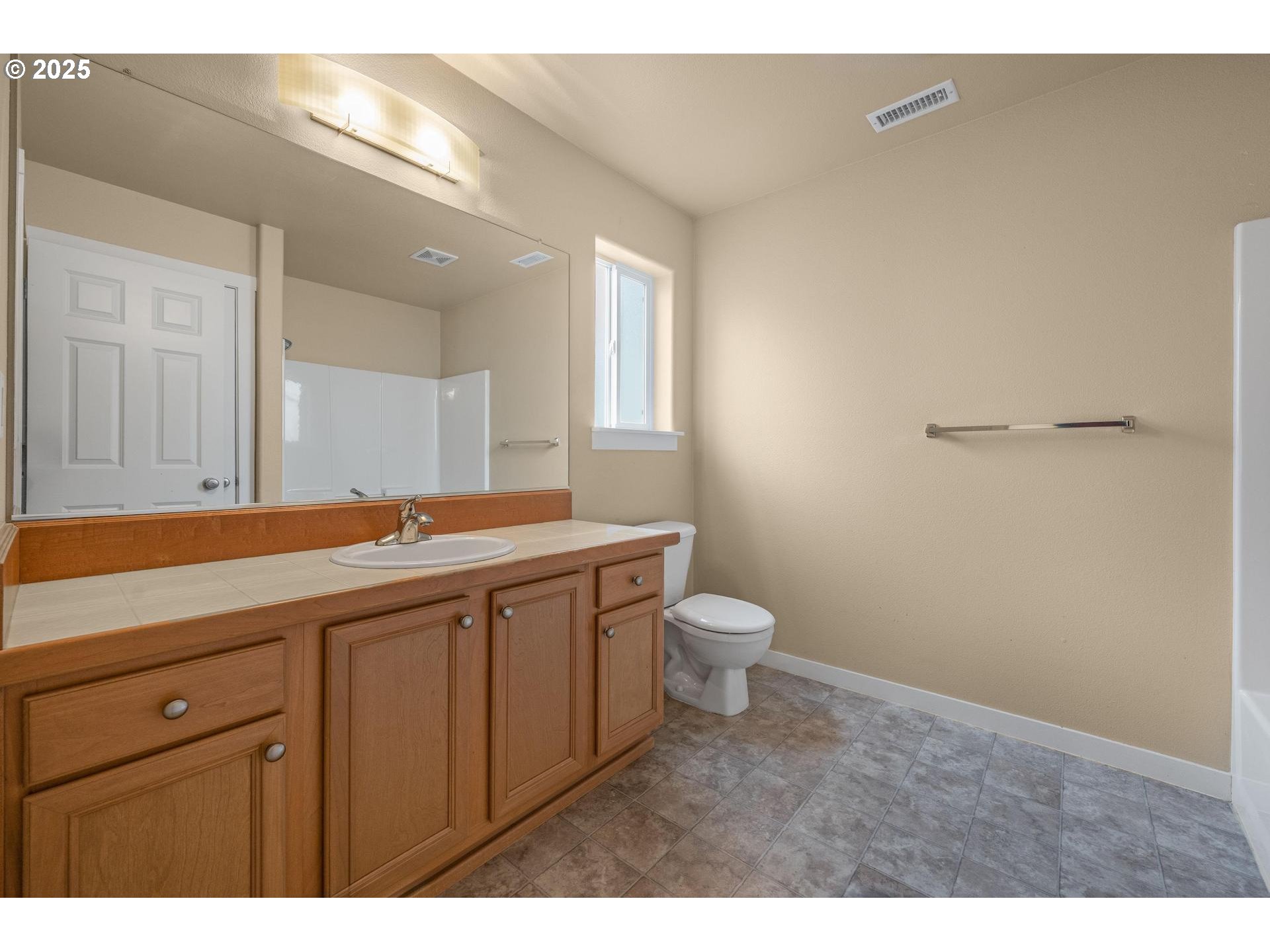 10797 Southwest Washington Street Portland, OR 97225 - Photo 38 of 48 a bathroom with a toilet a sink and mirror