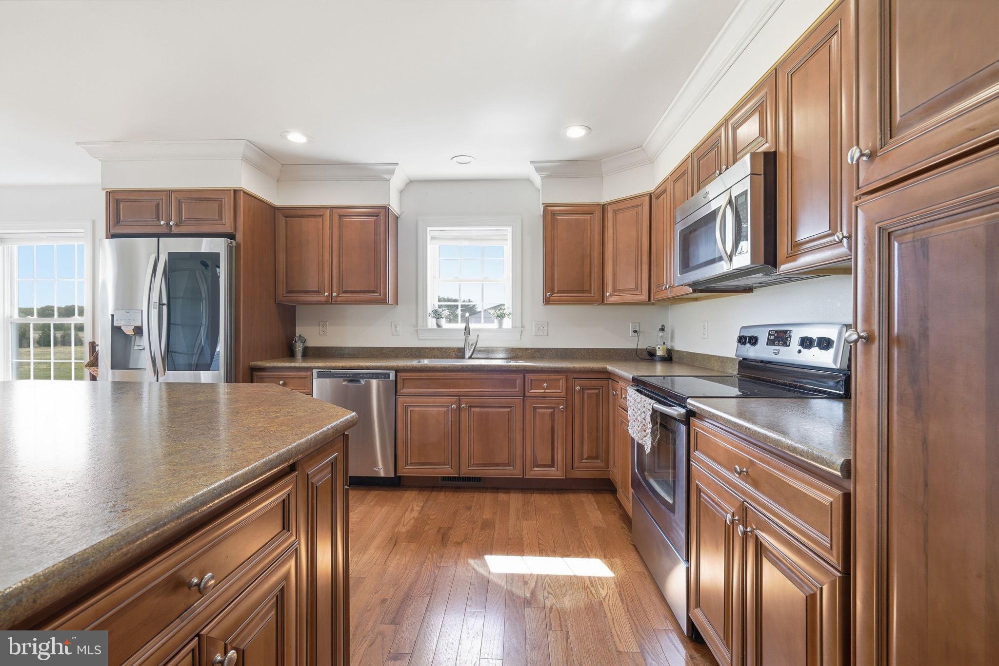 615 Ell Downes Road Henderson, MD 21640 - Photo 8 of 58 Warm wood tones in a bright kitchen.