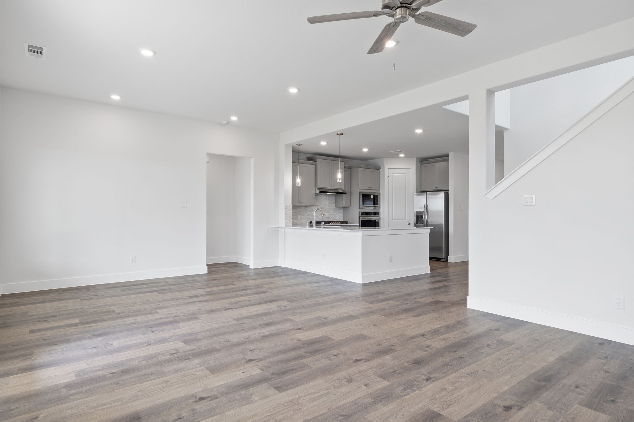 620 Cross Timbers Trace Waller, TX 77484 - Photo 7 of 36 a view of kitchen with kitchen island wooden floor center island and stainless steel appliances