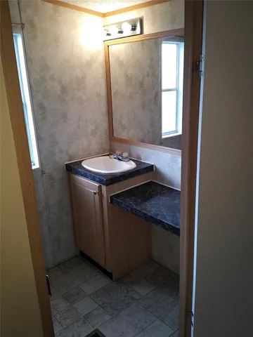 a bathroom with a sink and mirror