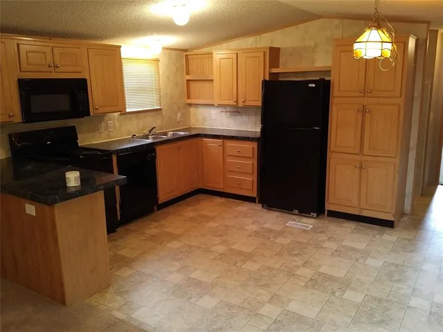 a kitchen with a refrigerator and a stove