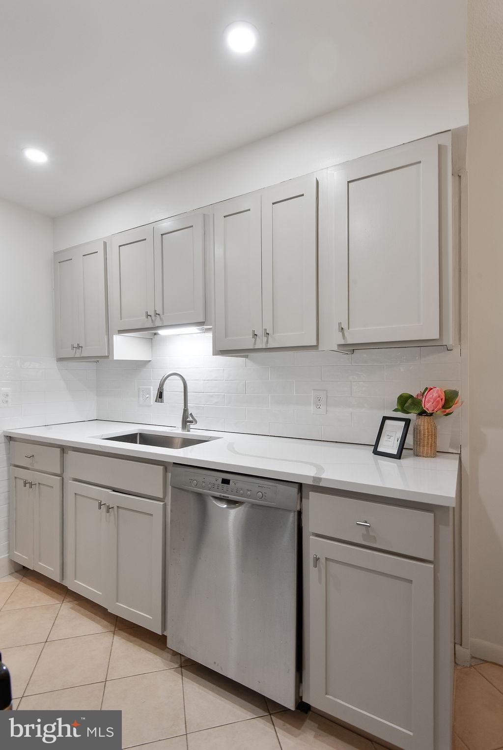 11600 Stoneview Square, Unit 60/2B Reston, VA 20191 - Photo 16 of 27 a kitchen with white cabinets sink and white appliances
