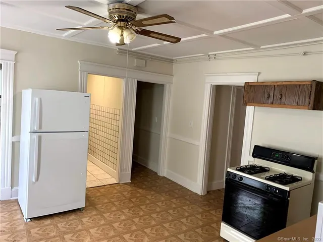 a kitchen with stainless steel appliances granite countertop a refrigerator a stove and a refrigerator