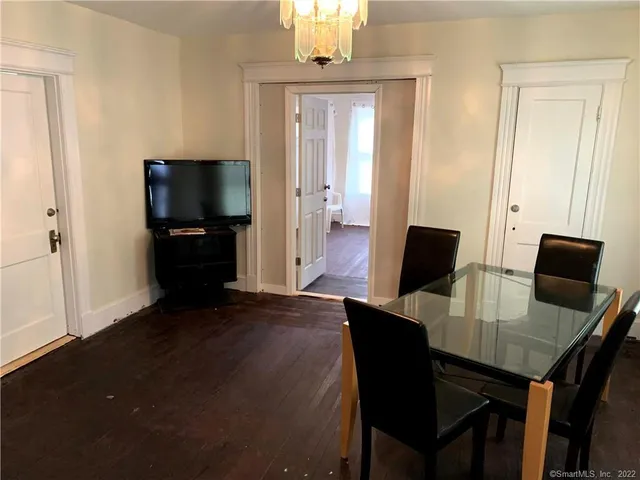 a view of a dining room with furniture and wooden floor