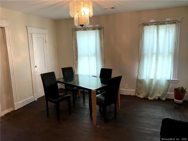 a view of a dining room with furniture and window