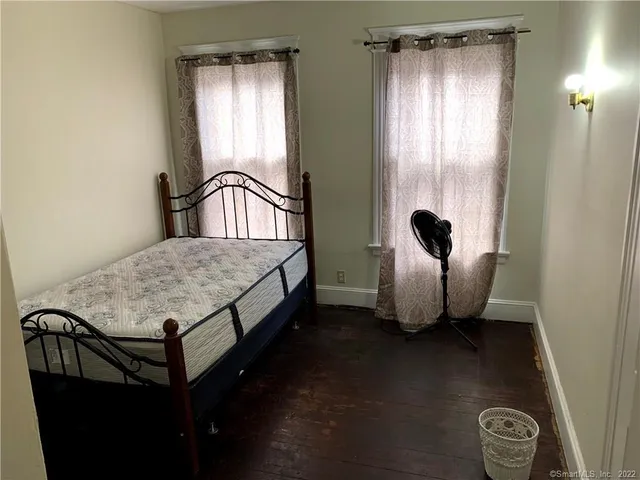 a bed sitting in a room next to a window