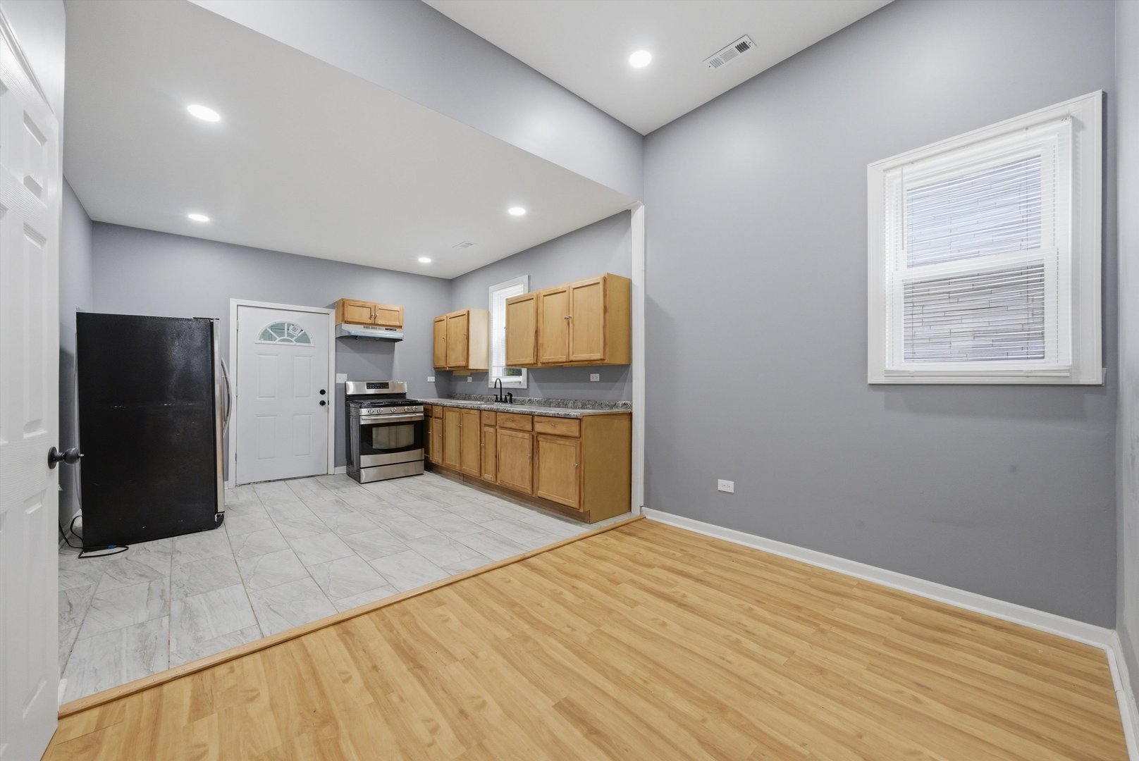 7828 South Escanaba Avenue Chicago, IL 60649 - Photo 12 of 41 a kitchen with stainless steel appliances granite countertop a refrigerator and a stove top oven