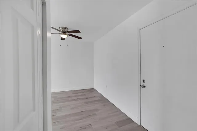 a view of a room with wooden floor