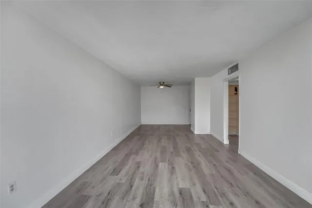 a view of a room with wooden floor